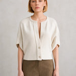 Cream short-sleeve button-front cardigan with drop shoulders and notched neckline