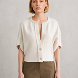 Cream short-sleeve button-front cardigan with drop shoulders and notched neckline