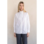 White long-sleeve button-front shirt with ruffle stand collar and wide cuffs