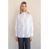 White long-sleeve button-front shirt with ruffle stand collar and wide cuffs