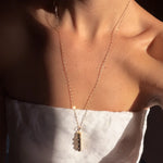 Thatch Clio gold capsule pendant necklace with small stones on delicate chain
