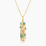Gold capsule pendant necklace with turquoise stones and pearls on rolo chain