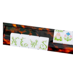 Tortoiseshell mahjong rack holding NEWS tiles, a Joker tile, and flower tile