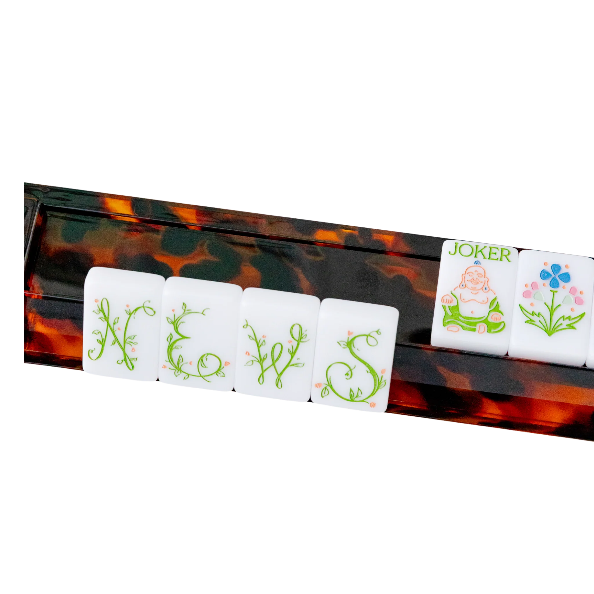 Tortoiseshell mahjong rack holding NEWS tiles, a Joker tile, and flower tile