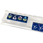 Clear acrylic scalloped mahjong rack holding navy blue floral and joker tiles