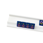 White wood mahjong rack holding navy blue mahjong tiles with pink and yellow design