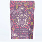 Zorro Pecans dark chocolate pecan bark 8oz purple bag with fox illustrations