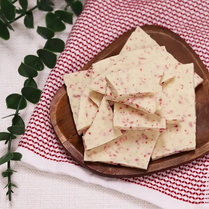 Zorro Pecans white chocolate peppermint bark pieces on a wooden plate