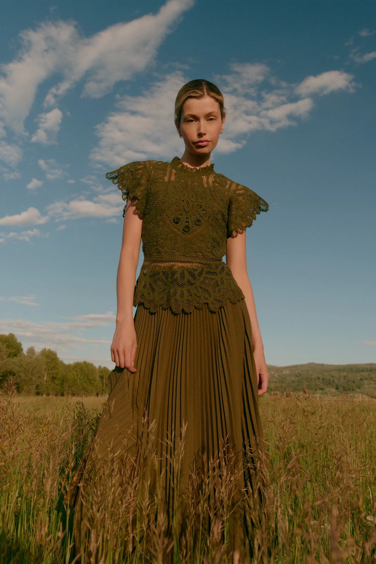 Olive green crochet lace top with flutter sleeves and scalloped hem detail