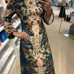 Hunter Bell Townes Dress in cream and teal floral parrot print with bell sleeves