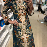 Hunter Bell Townes Dress in cream and teal floral parrot print with bell sleeves