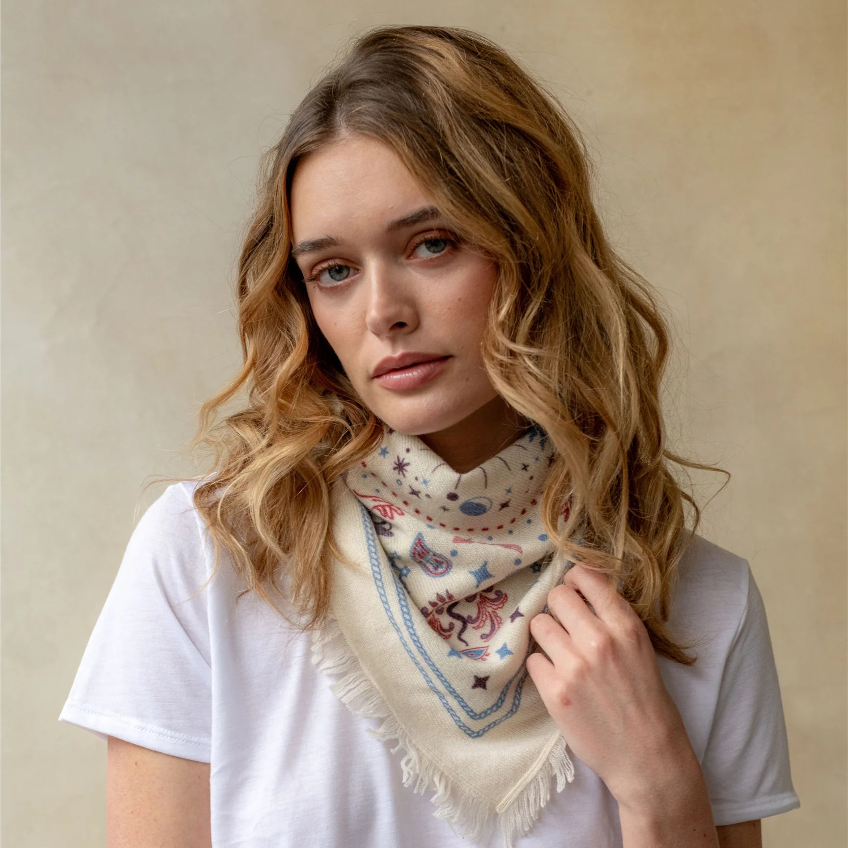Cream cashmere bandana wrap with celestial bird print and fringe edges