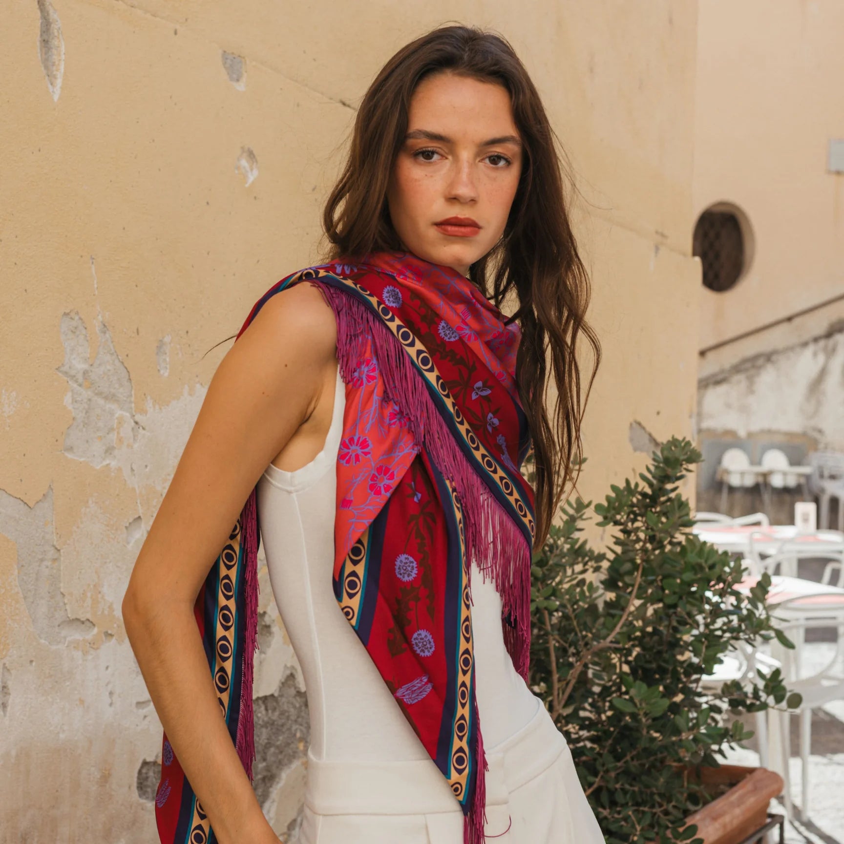 Red floral silk bandana scarf with pink fringe trim and geometric border