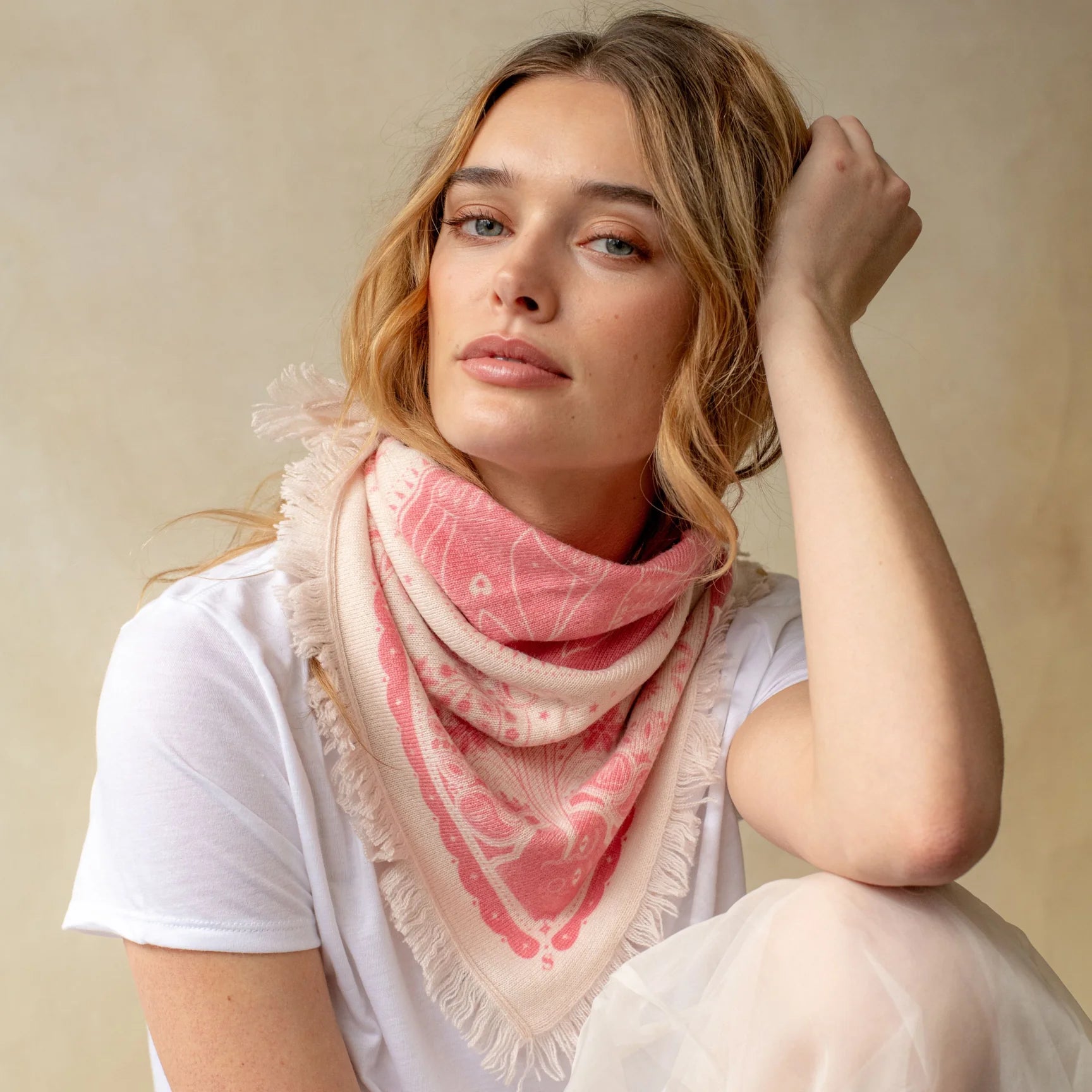 Pink cashmere bandana wrap with celestial bird print and fringe edges