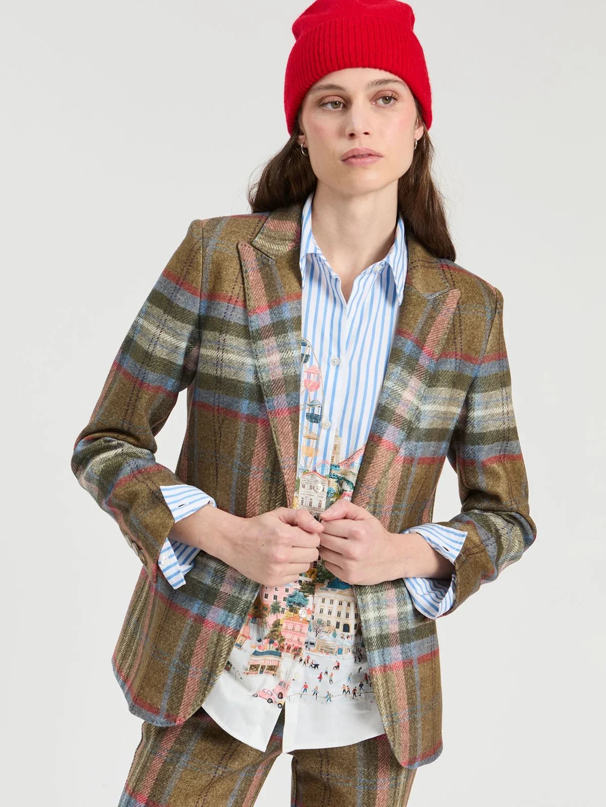 Brown plaid wool blazer with red and blue check pattern worn over striped shirt